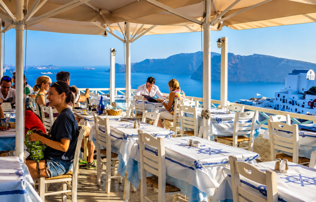 Greece culture and local customs at an outdoor café in Oia, Santorini
