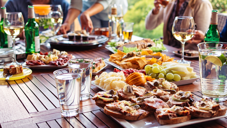 Italian food spread served on a table with cheese, bread and regional dishes