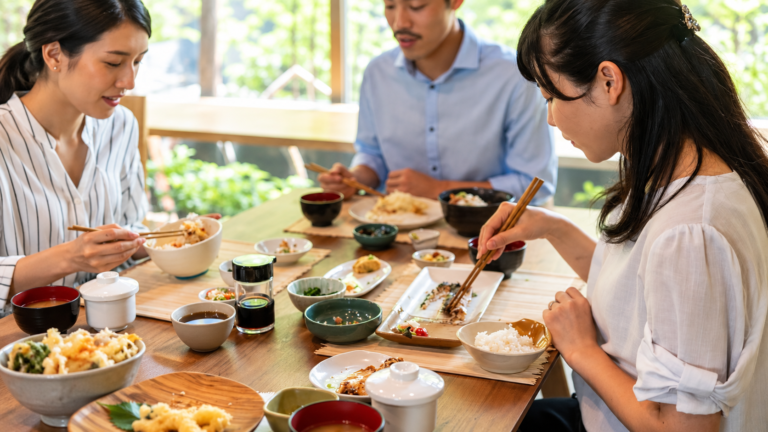 Japanese diners sharing a traditional meal with rice, soup and small dishes