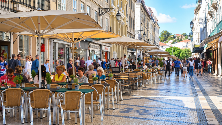 What to eat in Portugal – people dining at outdoor café tables in Lisbon