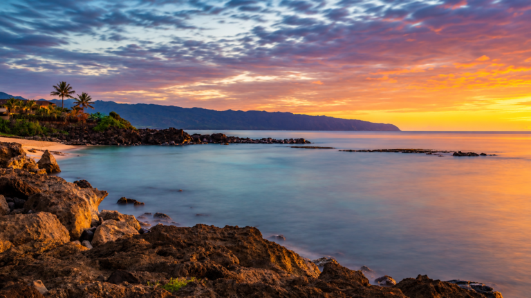 United States coastlines at Haleiwa, Hawaii, with rocky shore and sunset over the Pacific