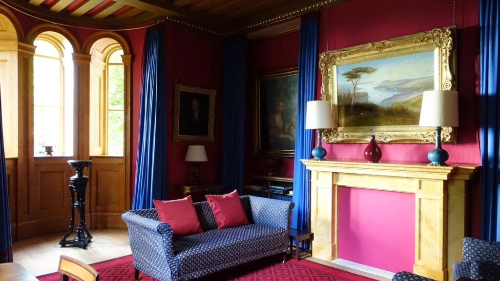 Travel accommodation interior with sofa, fireplace, artwork, and arched windows